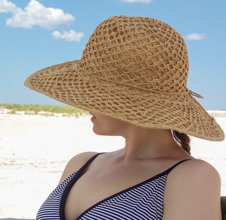 woman with hat on beach