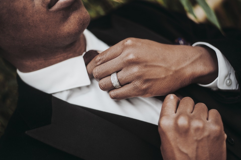 man fixing tie