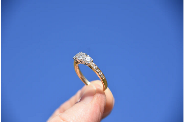 a person with a diamond ring